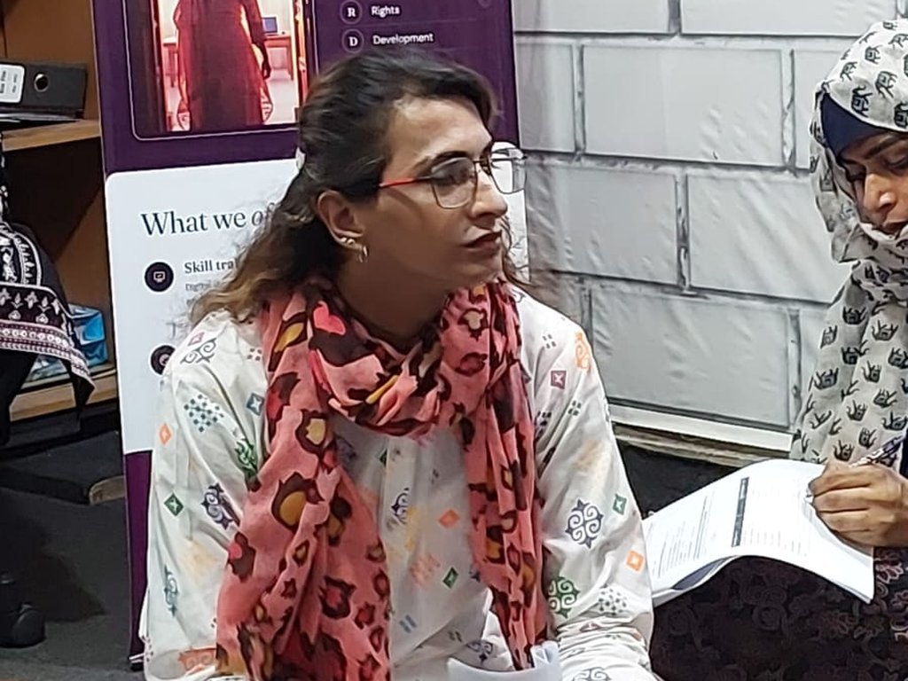 A participant speaking in front of a Degardis Skills belong to everyone banner